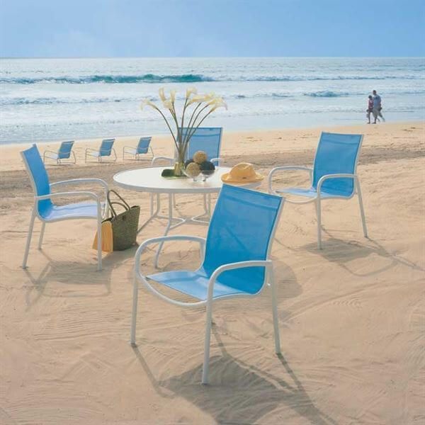 A Tropitone Millennia chair with a sled base highlights how sled-style frames prevent sinking and shifting when used on sand at beachfront properties.